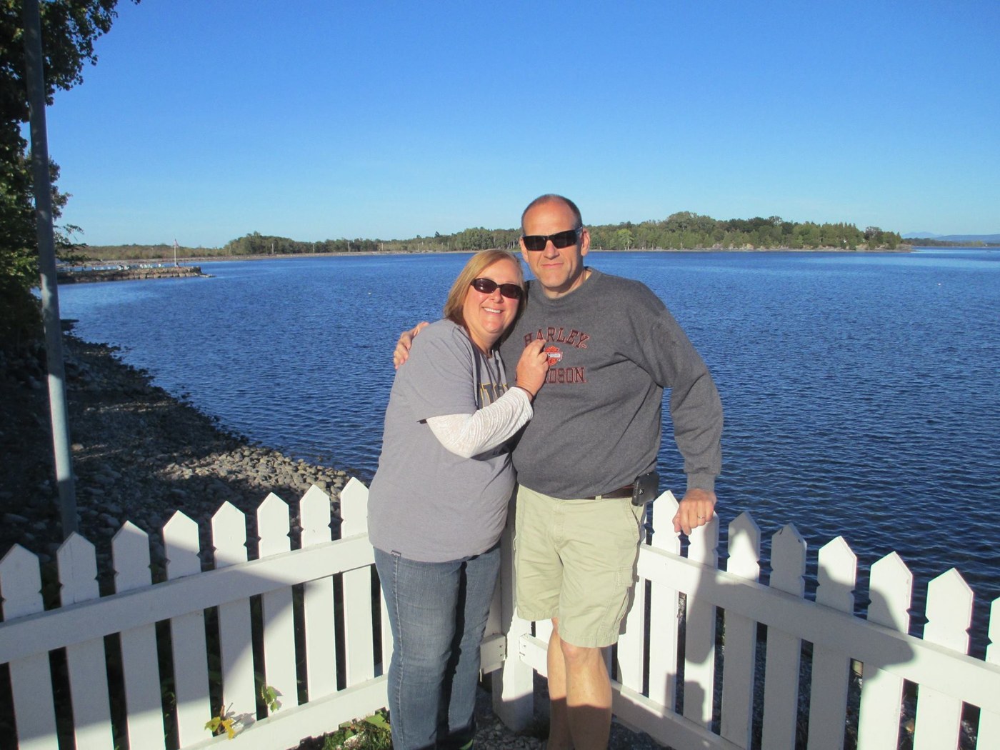 Tom and a loved one standing together beside the water