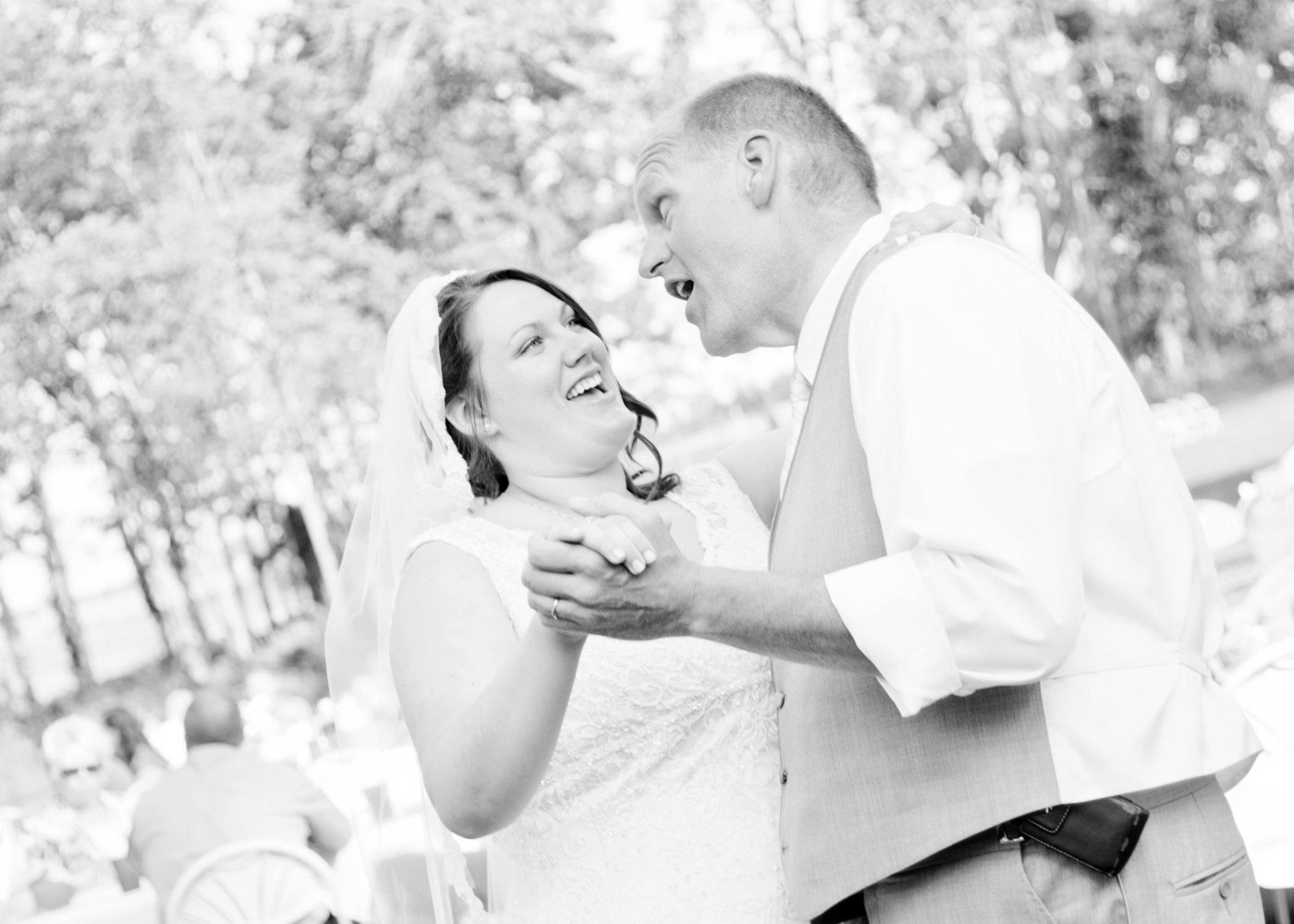Haley and her dad, Tom, laughing together during a dance at her wedding